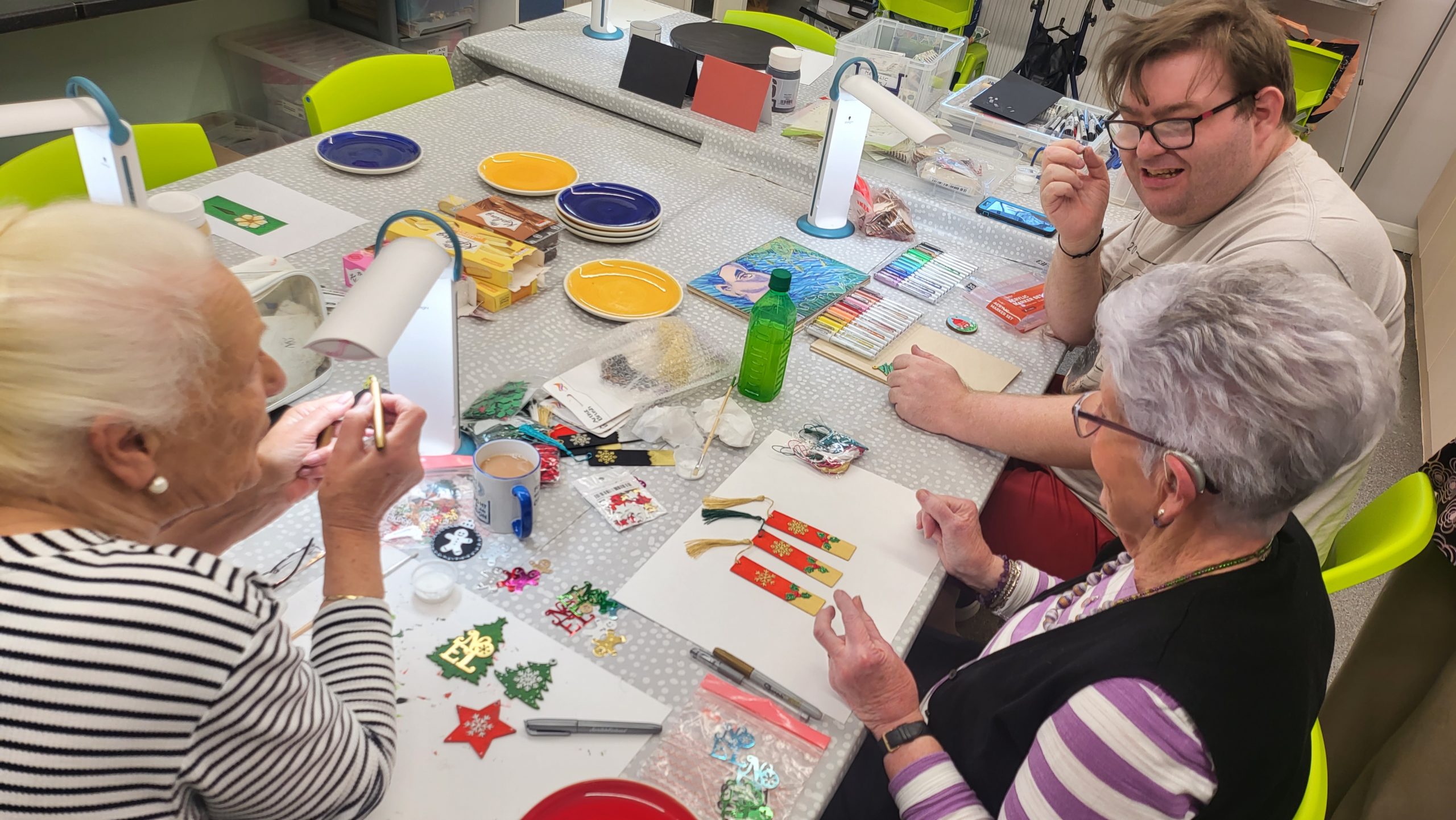 Three of our members enjoying taking part in a painting class.