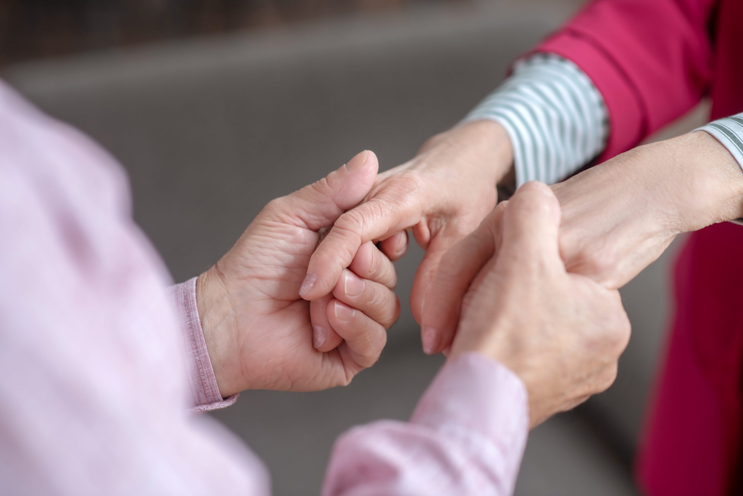 Close up picture of mans hands holding womans hands Close up image of a man holding a woman's hands.